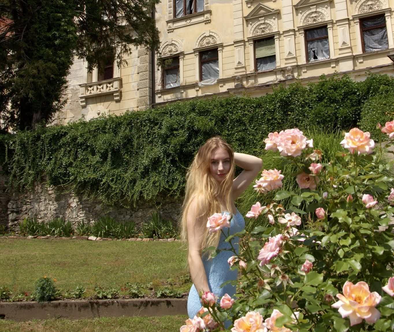 Urška among the roses, softly out of focus